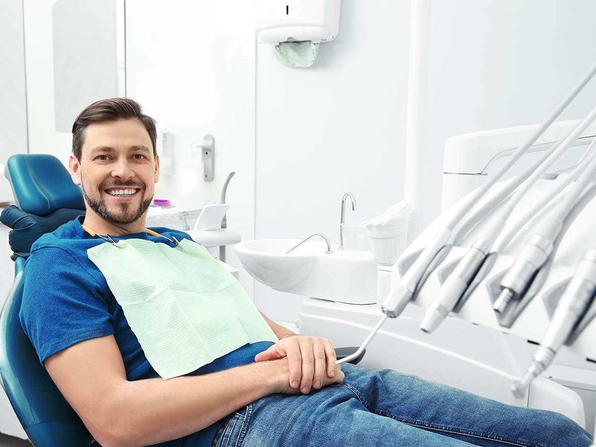 man smiling in dentist’s chair
