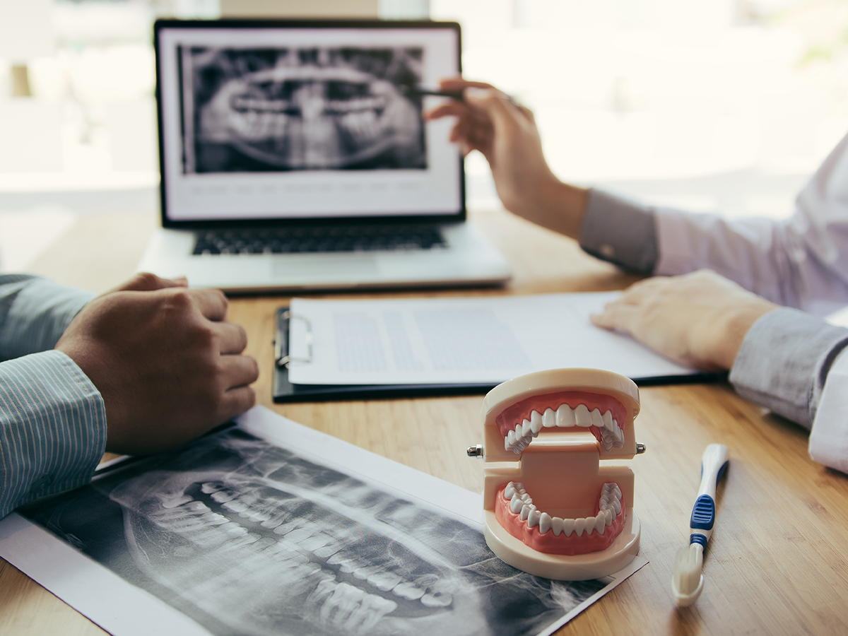 Dentist and patient looking over x-rays and discussing treatment