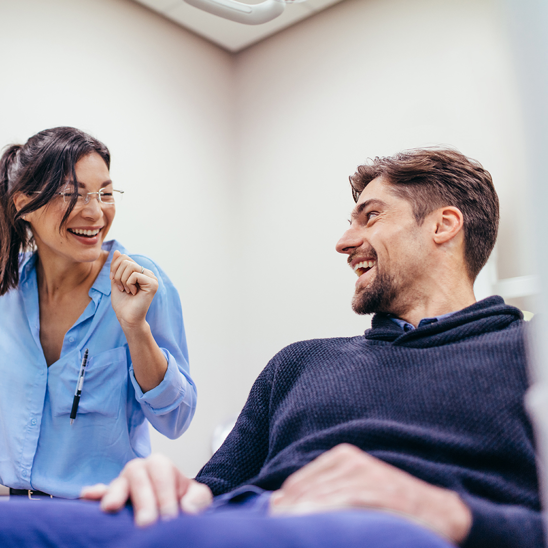 Image of a man laughing with his dentist