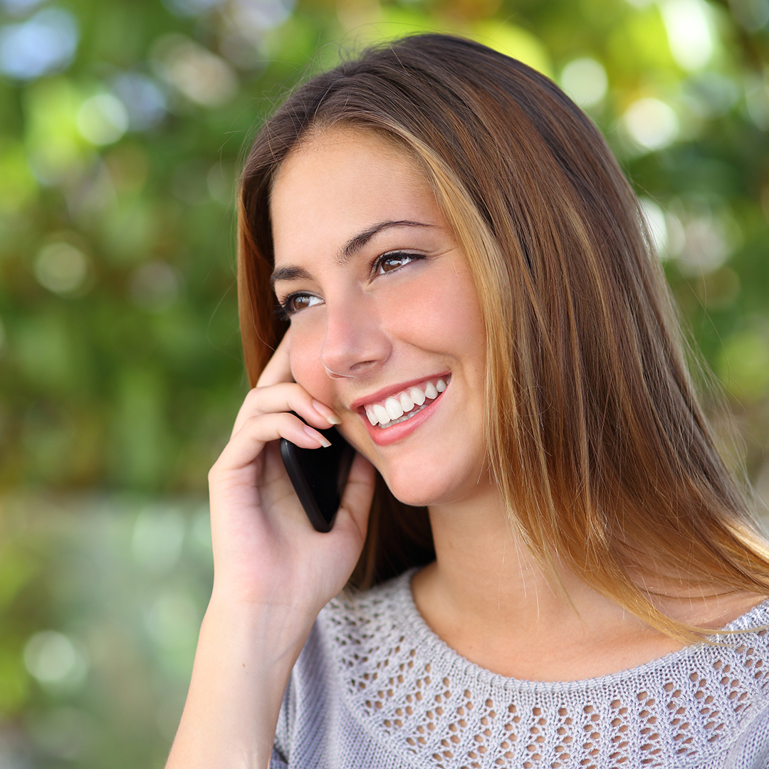 Image of a woman smiling on the phone