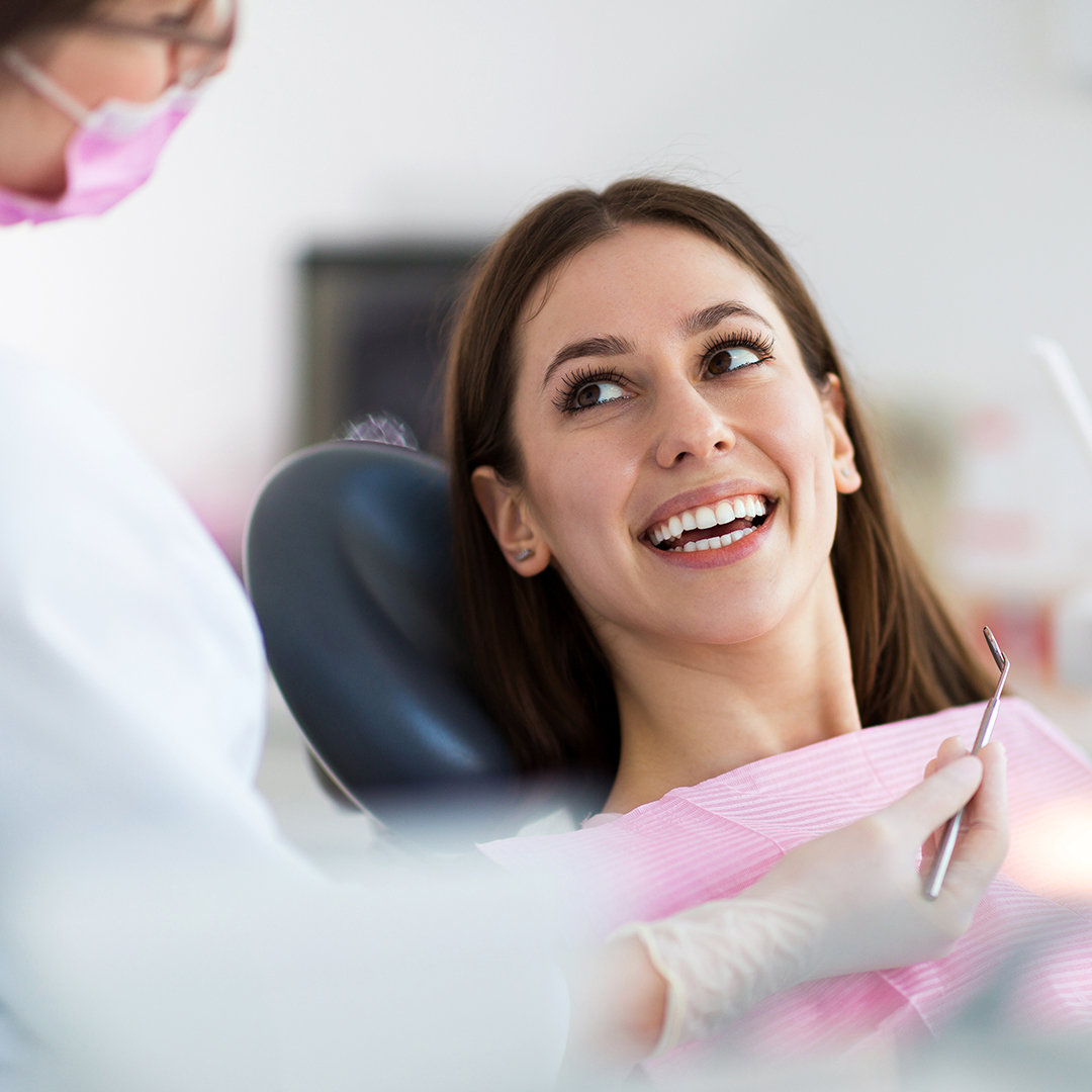 Image of a woman smiling in the dentist chair