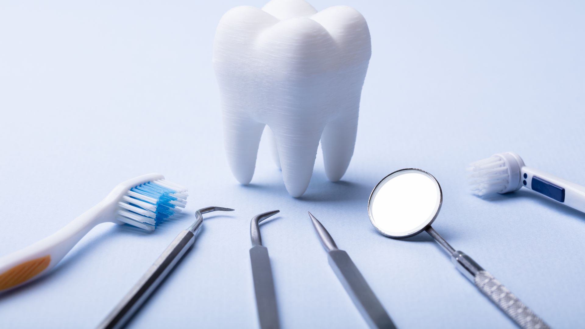 large tooth surrounded by dental equipment