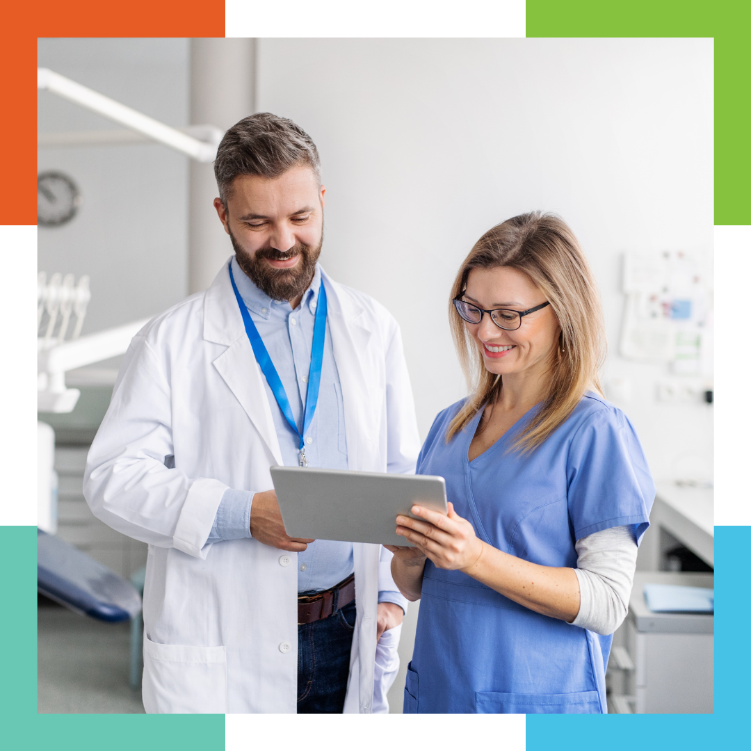 dentist and dental assistant looking at tablet