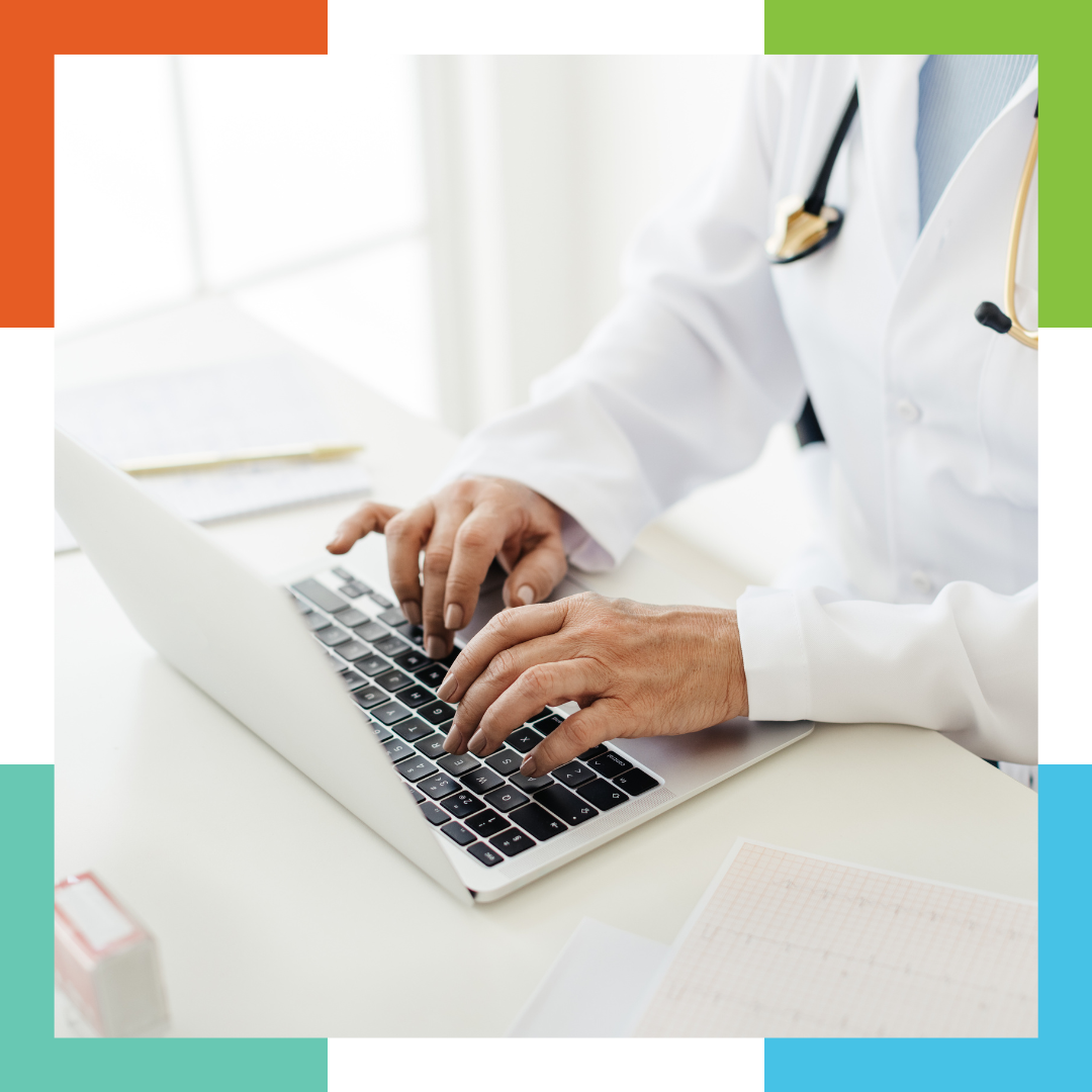 A dentist typing on a computer